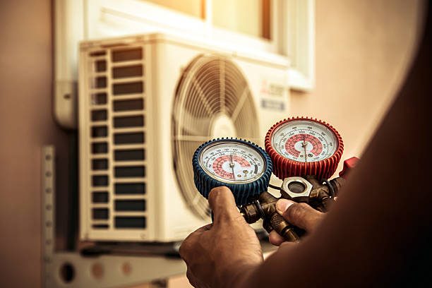 Professional Air Conditioning Service technician working in Dearborn, MO